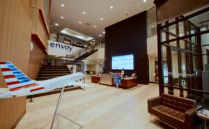 Inside the Enjoy Air headquarters. A model regional jet is seen in the foreground and a large Samsung display is in the background.